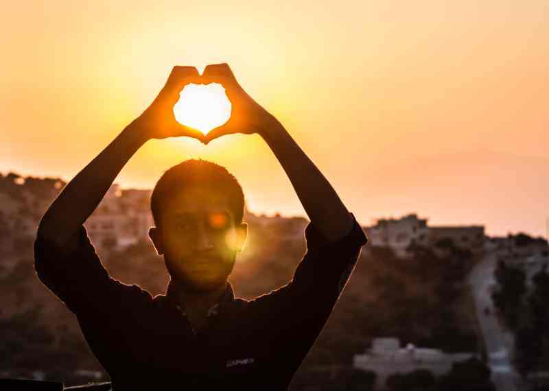 man with heart shaped hands